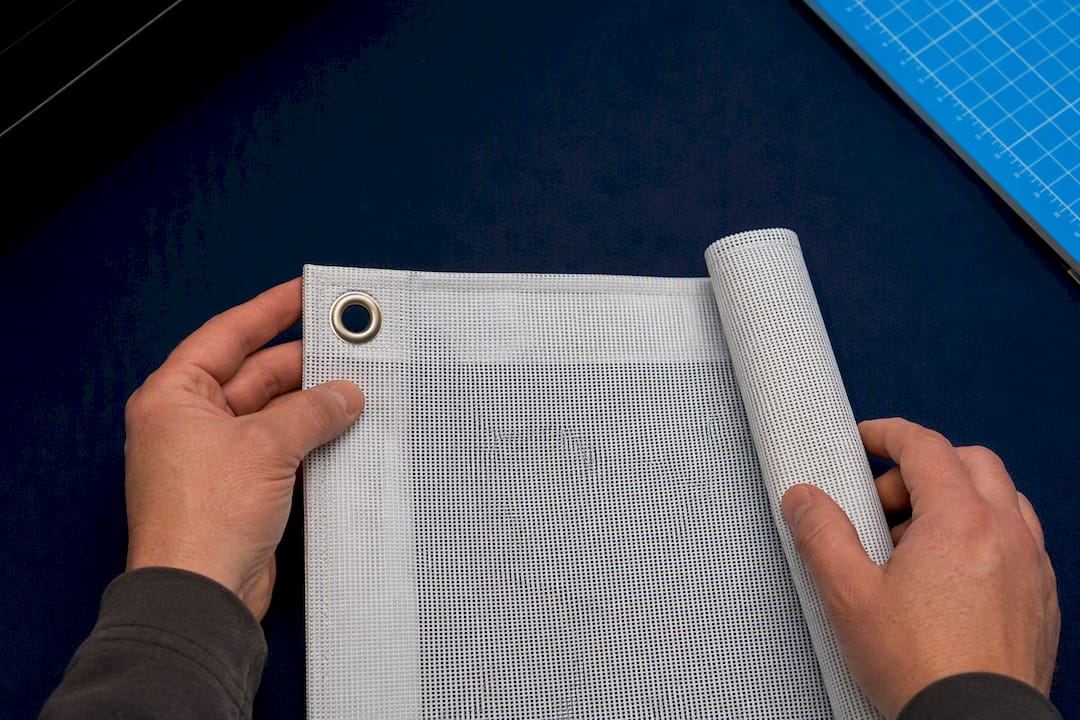 Reinforced banner hem and metal grommet
