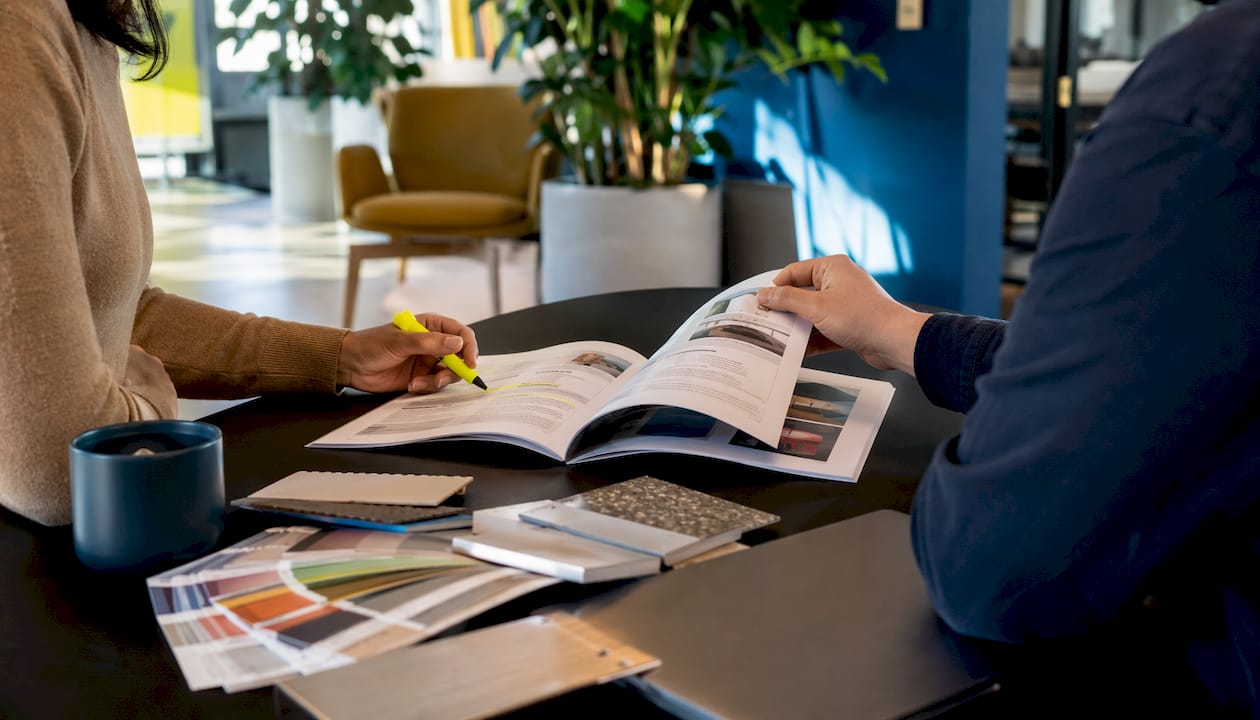 Hands reviewing signage compliance guidelines