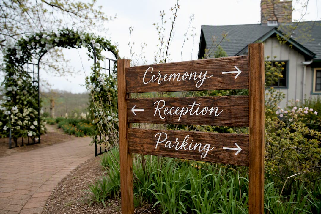 Rustic wood directional wedding sign outdoors