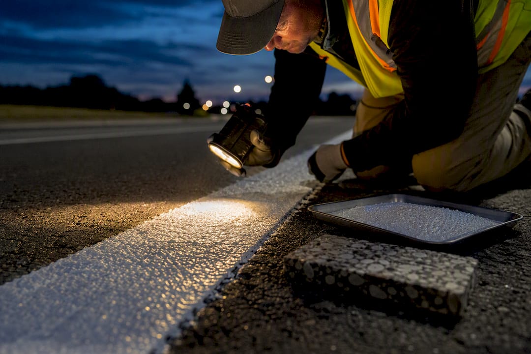 Reflective beads embedded in pavement marking