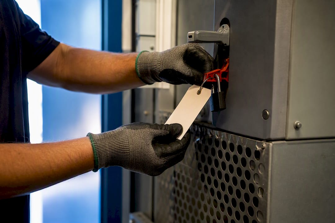 Worker attaching a temporary hazard tag